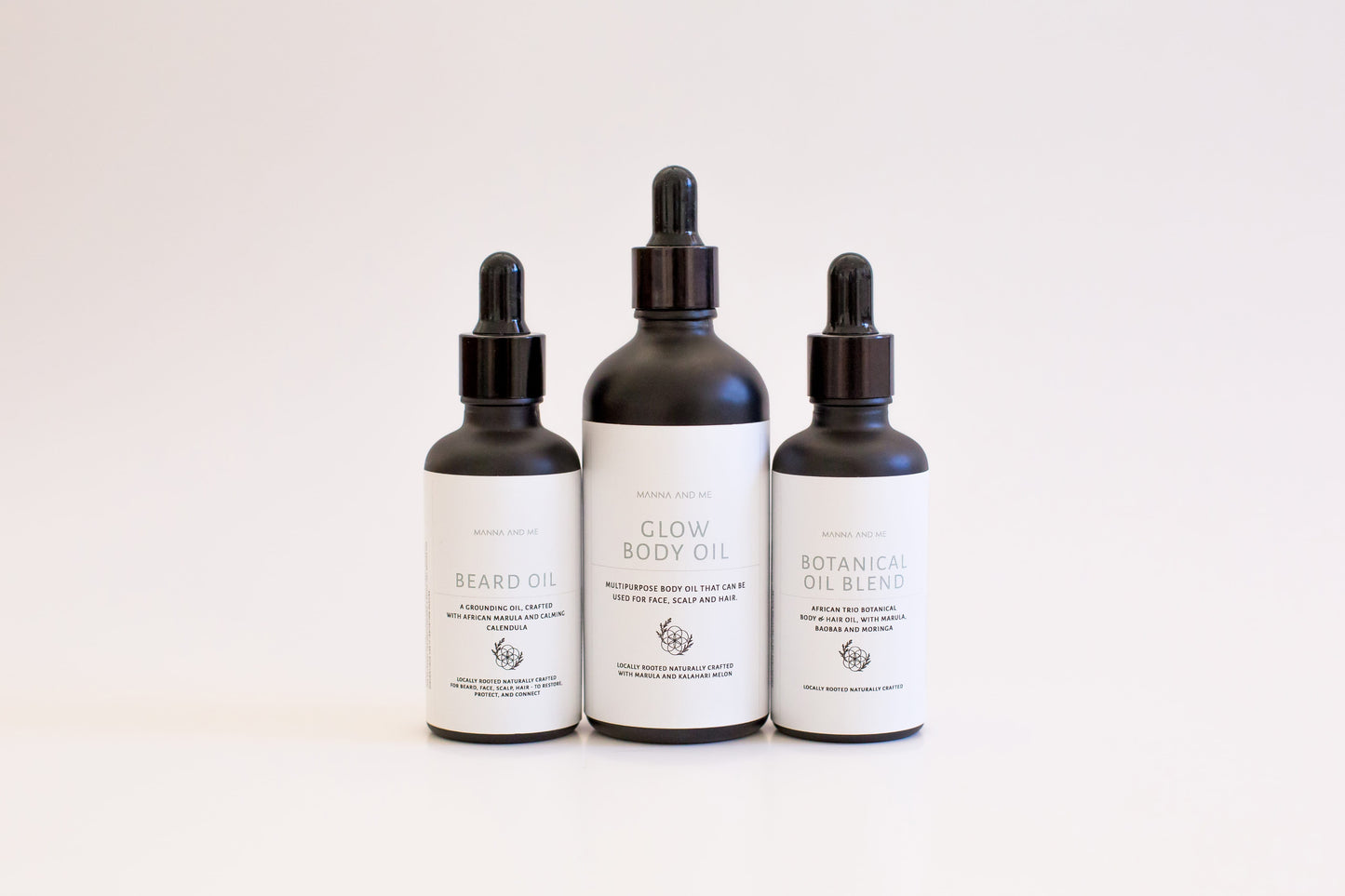 Manna and Me African Trio Body Oil bottle, deeply nourishing botanical body treatment for glowing skin.