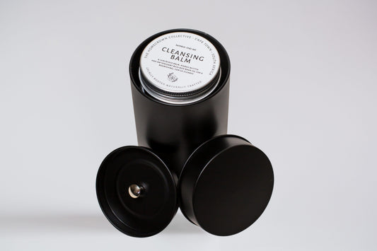 Manna and Me Ritual Discovery Set featuring four travel-size tins of natural skincare balms and creams.