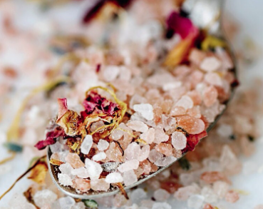 Manna and Me soothing herbal Bath Salts with pink mineral crystals and botanical petals.